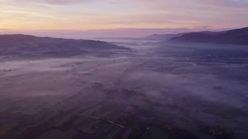 Aerial view of foggy countryside at sunrise, San Giuliano del Sannio, Italy.