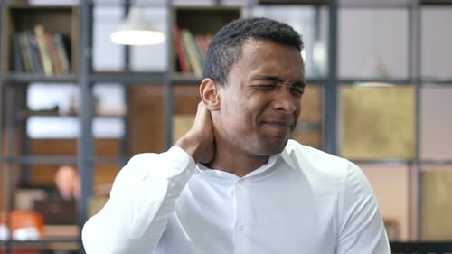 Tired Black Man in Office with Neck Pain