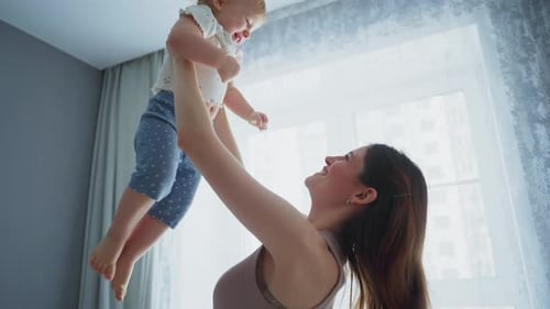 Loving Mother Playing with Baby at Home