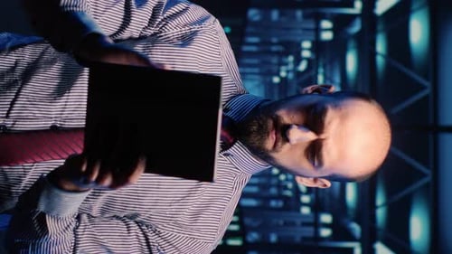 Man Using Tablet in Bright Server Room