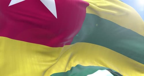 Togo National Flag Waving Seamless Loop in Bright Sky