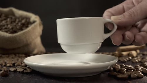 Coffee Cup Placed on Saucer with Coffee Beans