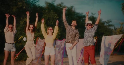 Happy Young Friends Jumping at Beach
