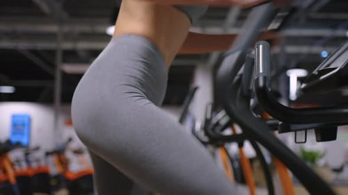 A Modern Advanced Woman Performs Sports Exercises in the Gym to Maintain a Beautiful Body Shape and