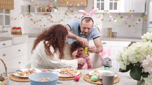 Loving Parents Playing with Easter Bunnies