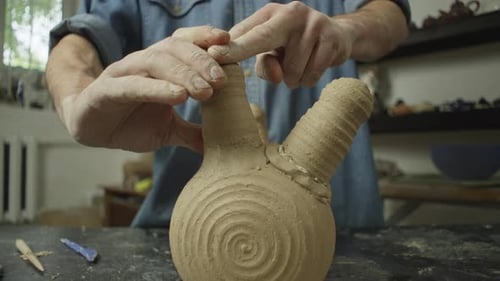 The Ceramist Adds the Detail to the Clay Product with Clear and Gentle Movements