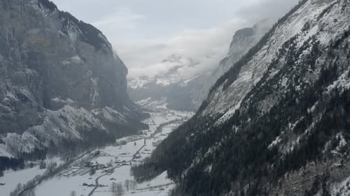Drone Aerial of Lauterbrunnen surrounded by the Mountain Eiger in the swiss alps. The winter in Swit