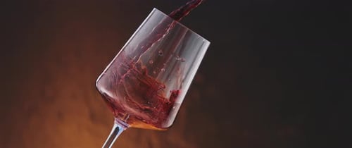 Red Wine Pouring into Glass Close Up