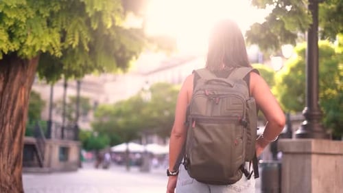 Tourist woman visist city urban sightseeing by girl pov rear view