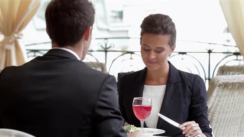 Charming Couple Enjoying a Business Lunch on a Terrace