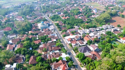 Drone view from top of local village house with street, Motorbikes and car driving through the way