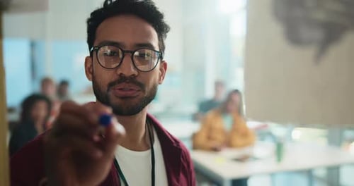 Young Man Presenting to Students in Classroom