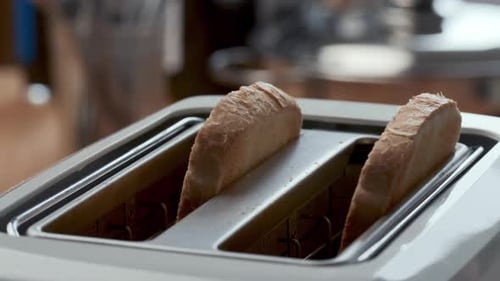 Bread Being Placed Into Toaster For Breakfast