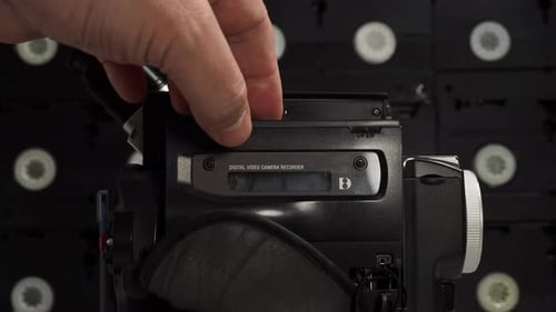 Change the cassette of an old video camera.