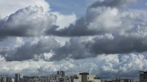 Time Lapse of Clouds Moving Over Cityscape
