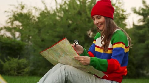 Young Woman in a Red Hat Checks the Map