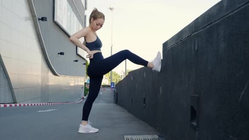 Young Woman Sport Exercise Outdoors in City Displays Healthy Lifestyle Athlete Performing Yoga