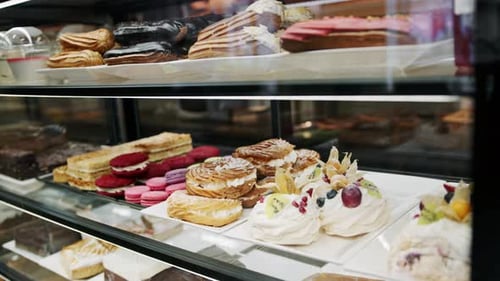 Counter full of delicious buns and pastries in a shop, bakery