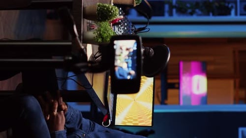 Man Talking On Phone Attached To Microphone