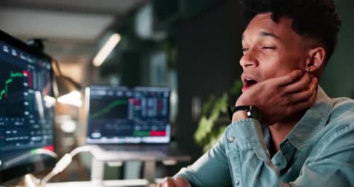 Business, man and tired trader on computer at night with stock market statistics