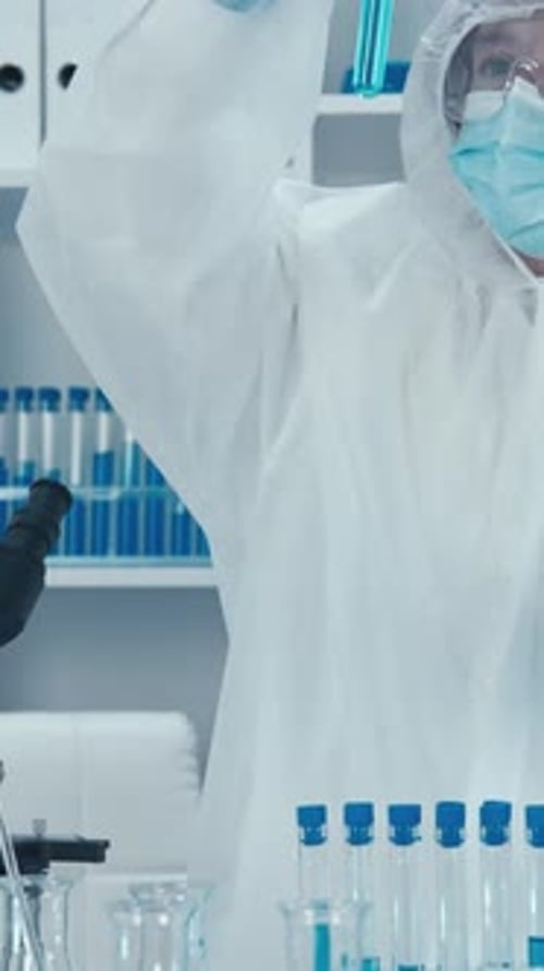 Scientist Analyzing Test Tube Sample in Laboratory