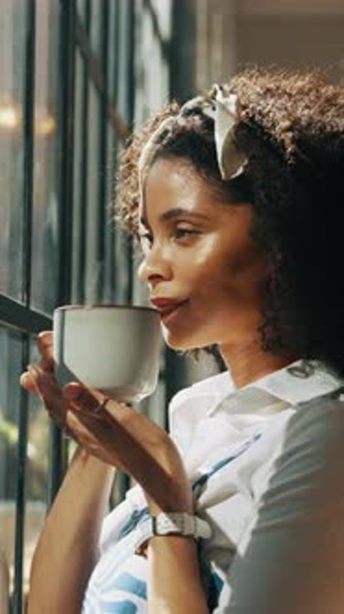 Woman Drinking Coffee at Window