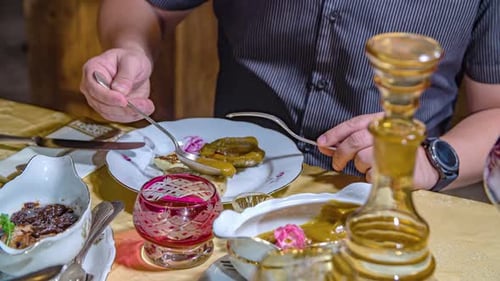 close up shot of a man spoon mustard sauce over the meat at restaurant