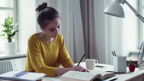 Woman Studying with Book and Pencil Indoors