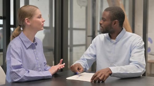 Close up of Creative African Man Talking with Female Colleague