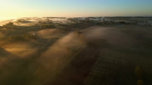 Misty Sunrise Over Rolling Countryside, Aerial View