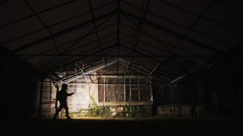 Investigating Abandoned Building With A Flashlight