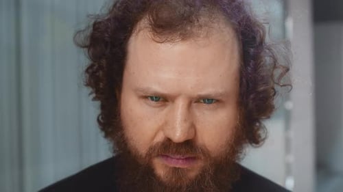 Man with Blue Eyes Stares at Camera