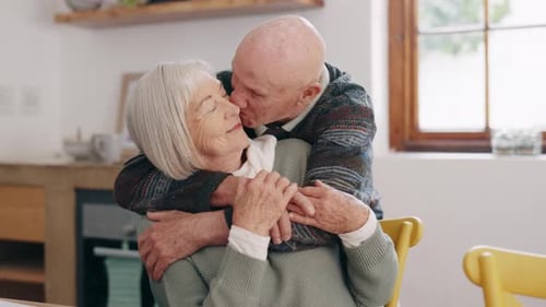 Senior Couple Embrace in their Home