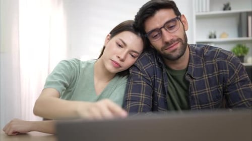 Romantic Couple Smiling Together at Laptop Computer Indoors