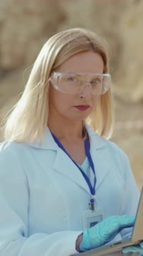 Woman Scientist Working with Laptop in Desert