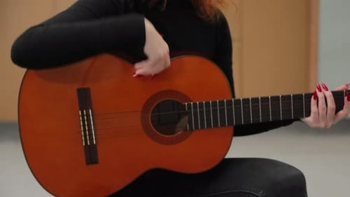 Woman Plays Acoustic Guitar Indoors