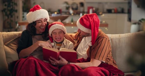Family Reading Together on Couch at Christmas