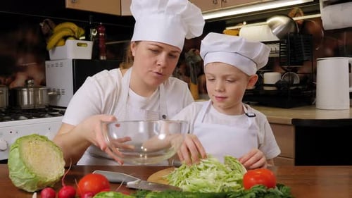 Adult and Child Preparing Cabbage in Kitchen
