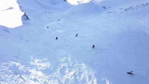 Aerial view of People Skiing and snowboarding on hill, Ski Resort.