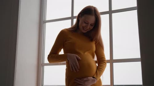 Happy Pregnant Woman Expecting Baby Beautiful Affectionate Female Mother in Orange Dress Enjoying