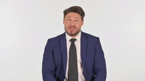 Man in Suit Talking and Gesturing on White