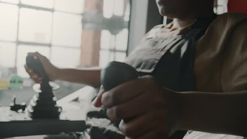 Female Technician Testing Gear Sticks in Tractor Cabin
