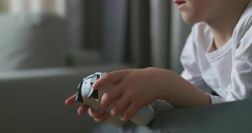 Child Playing with White Game Controller