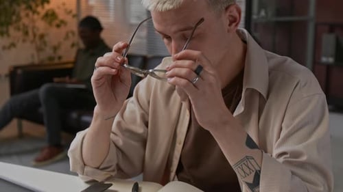 Young Man Having Eye Fatigue At Work