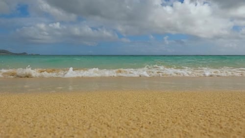 Low-angle pov shot of waves rolling on beach and flipping the GoPro upside down in Lanikai Beach