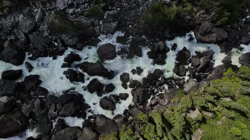 Top Down Aerial View of the Cascading Waterfall Flowing Over Rocks