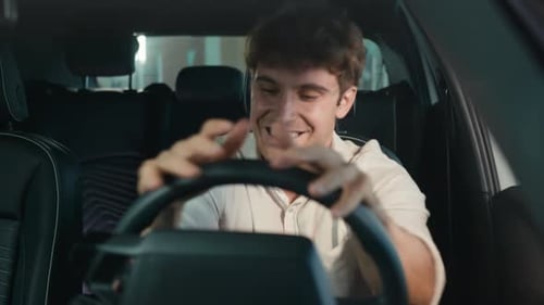 Frustrated Man Resting on Steering Wheel in Car