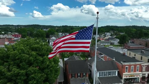 American Flag Waving Over Small Town