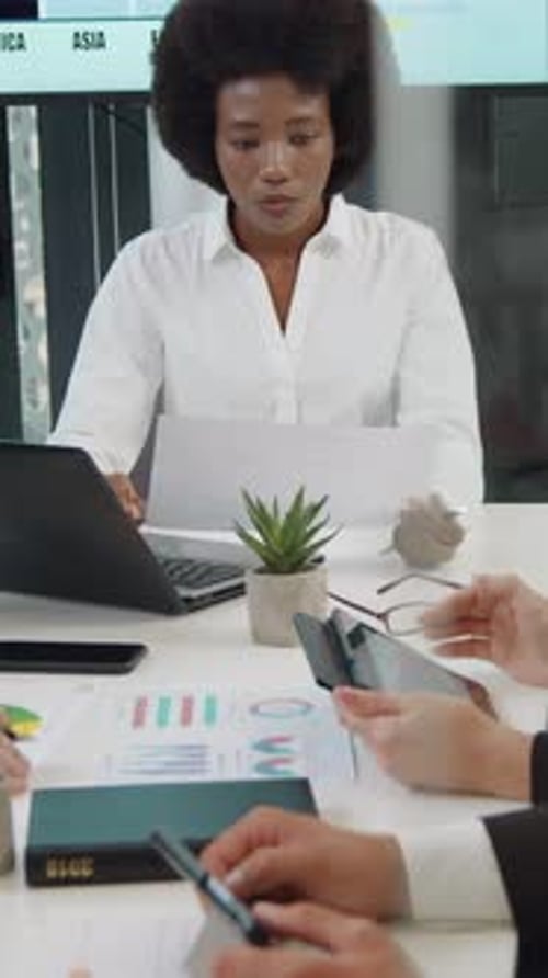 Business Meeting with Charts and Graphs in Office