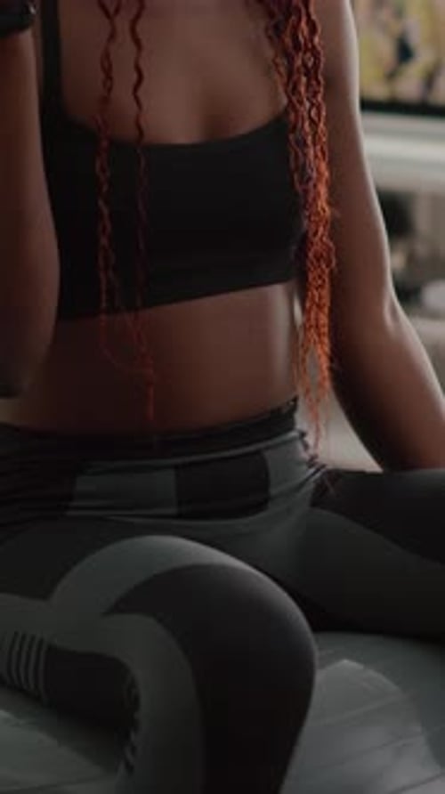 Athletic Woman Working Out with Dumbbells on Fitness Ball